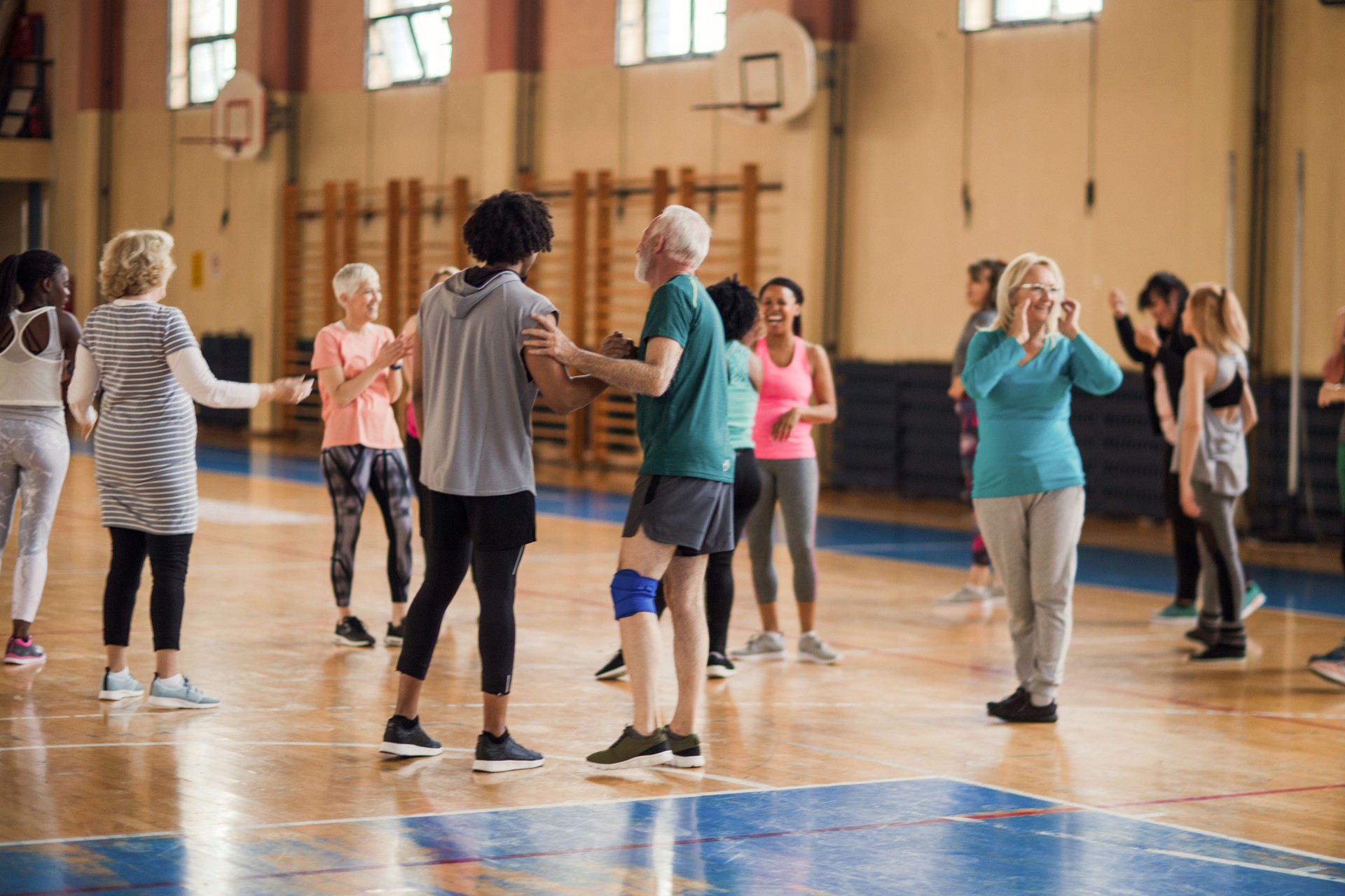 Smiling, enthusiastic people cheering in dance class