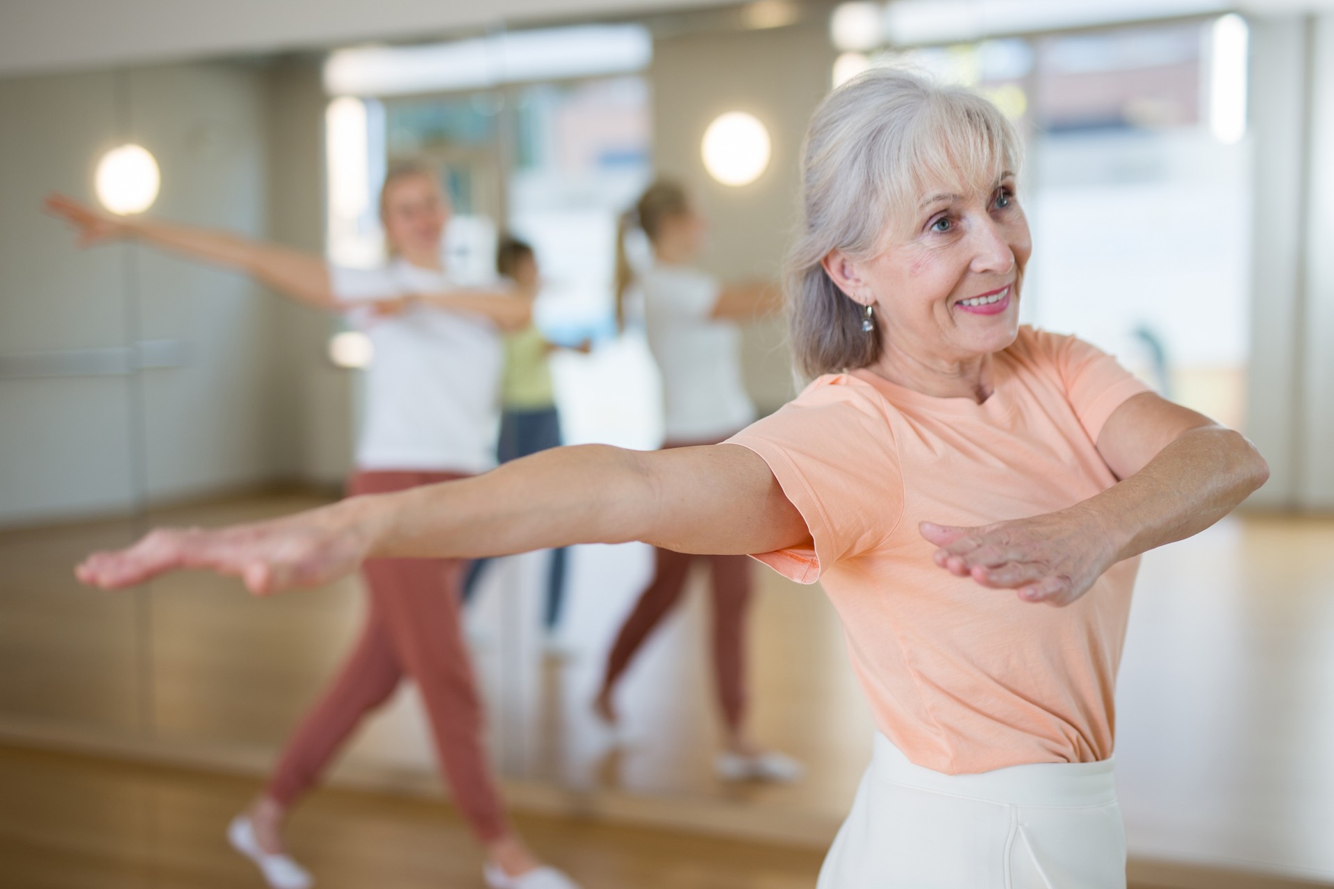 Senior woman performing contemporary dance in studio